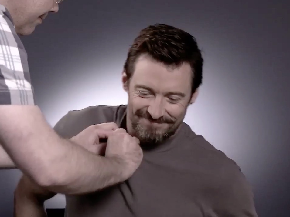 Carl fitting a microphone to Hugh Jackman during a Sky Movies shoot