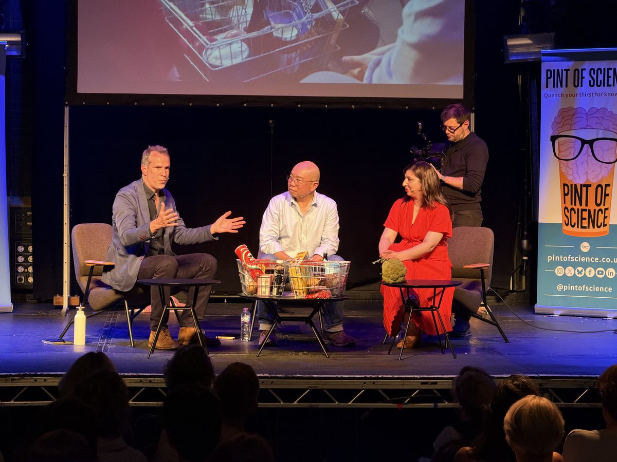 A panel discussion being filmed in front of a live audience